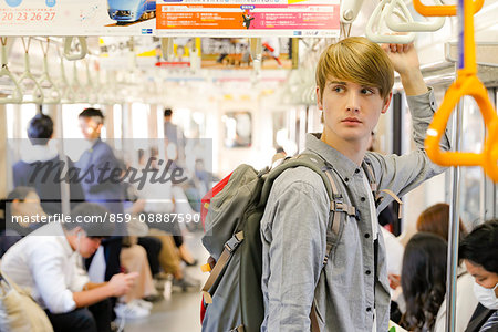 Caucasian tourist boarding a train, Tokyo, Japan