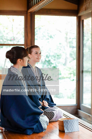 Caucasian woman wearing yukata with Japanese friend at traditional ryokan, Tokyo, Japan