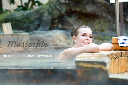 Caucasian woman bathing at traditional hot spring, Tokyo, Japan Caucasian woman bathing at traditional hot spring, Tokyo, Japan