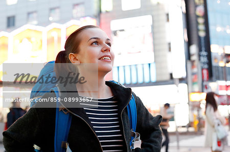 Caucasian backpacker downtown Tokyo at night, Tokyo, Japan