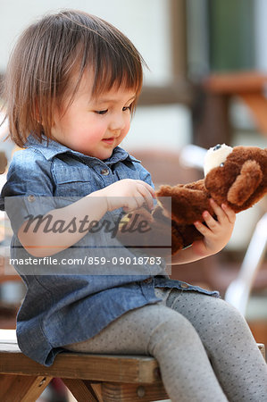 Mixed-race young girl with teddy bear