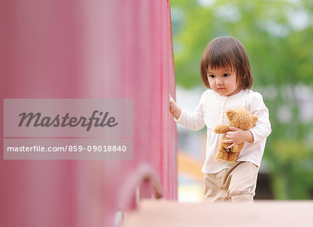 Mixed-race young girl playing at the park