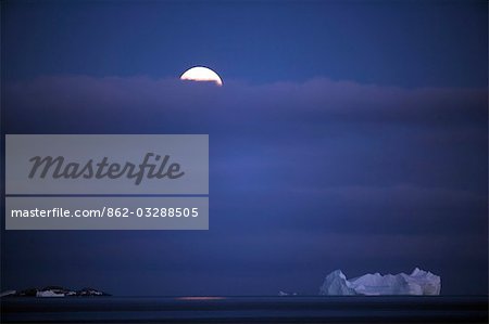 Antarctica,Antarctic Peninsula,Antarctic Sound. Moonrise over the tabular icebergs the sound.