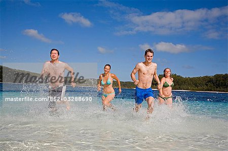 A group have fun in the clear waters of Lake Mckenzie on Fraser Island. Ringed by a white sandy beach,the popular swimming hole is one of the many naturally formed lake on the World Heritage Listed sand island.