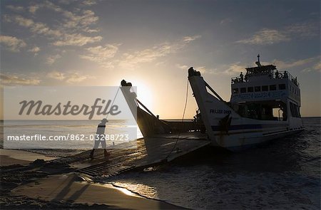 A man walks aboard the Fraser Dawn - a car ferry that transports vehicles from the mainland to a beach landing at Moon Point on Fraser Island.