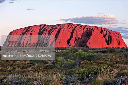 Australia,Northern Territory. Uluru or Ayres Rock,a huge sandstone rock formation,is one of Australia’s most recognized natural icons. The rock appears to change colour in different lights.