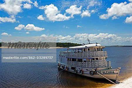 Brazil,Amazon,Rio Tapajos. A tributary of the Rio Tapajos which is itself a tributary of the Amazon has the Saude Alegria river boat secured its banks during the low waters of the dry season.