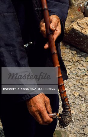 A villager lights his pipe