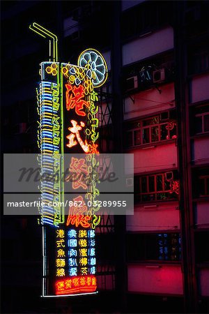 A giant neon sign illuminates apartment blocks in the Central district on Hong Kong Island