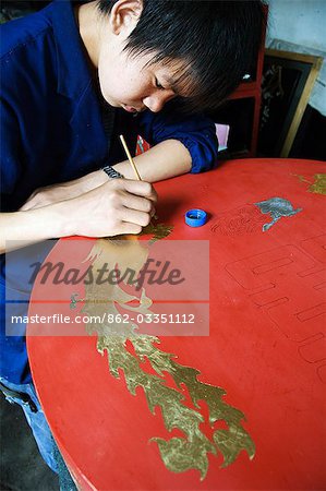 A local craftsmen painting at a museum in Pingyao City,Shaanxi Province,China