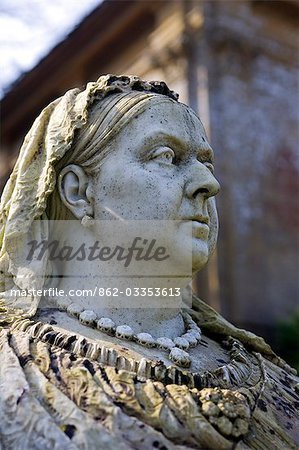 England,Dorset. Athelhampton House - stern faced Queen Victoria overlooks Athelhampton House. It is one of the finest examples of 15th century domestic architecture in the country. Medieval in style predominantly and surrounded by walls,water features and secluded courts.
