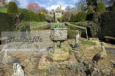 England,Dorset. Mapperton House is a romantic valley garden deep into a lost Dorset combe among tumbling hills and unspoilt countryside. The gardens descend from the great lawn,through the formal topiary down to the woodland garden. Pevsner's Dorset guide reckons there can hardly be a more enchanting manorial group than Mapperton.