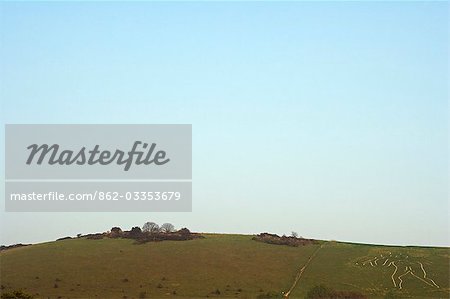 England,Dorset,Cerne Abbas. The Cerne Abbas Giant or the 'Rude Man' is the largest hillfigure in Britain,he is one of two representations of the human form,the other being the Long Man of Wilmington in East Sussex. The giant,carved in solid lines from the chalk bedrock,measures in at 180 feet high,and carries a huge knobbled club,which measures 120 feet in length.