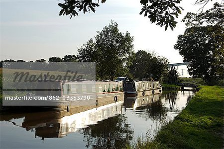 England,Shropshire,Whitchurch. Barges on a tranquil section of the Shropshire Union Canal.