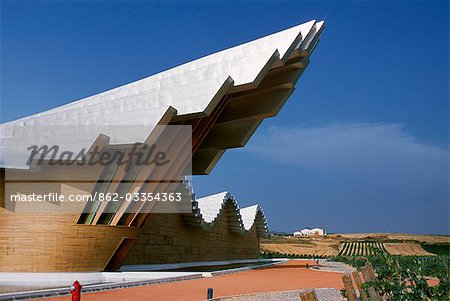 The striking centre-piece Ysios winery,designed by world renowned architect Santiago Calatrava,protrudes from the undulating aluminium roof like the prow of a ship