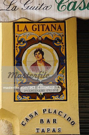 Painted ceramic mural at the entrance to a tapas bar in the Santa Cruz district of Seville,Spain