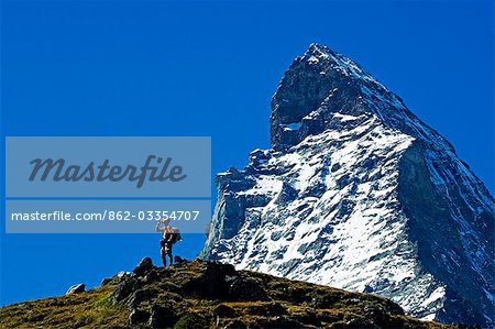 The Matterhorn (4477m). Hiker on rrail below the Matterhorn's peak