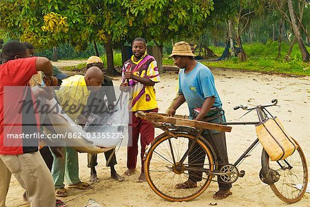 East Africa; Tanzania. A fishermen buying & selling fish at a fish market in Nungwi Village,Zanzibar Island East Africa; Tanzania. A fishermen buying & selling fish at a fish market in Nungwi Village,Zanzibar Island