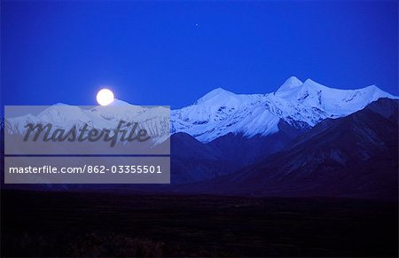 Full moon coming up over the Alaskan Range