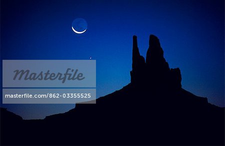 The Moon and Venus rise over the Mittens,one of the most famous rock formations in Monument Valley