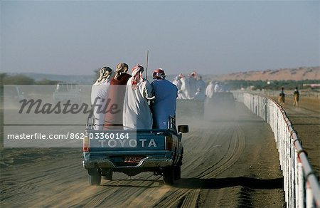Spectators follow alongside the racing camels in four wheel drive vehicles,shouting instructions and encouragement and generally adding to the excitement and confusionn of the event at Al Shaqiyah races.