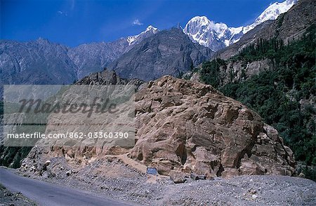 The Sacred Rock of Hunza,beside the Karakorum Highway near Karimibad,Northern Pakistan. Altit Fort just visible on the cliff in the distance.