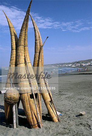 Totora (reed) fishing boats are stacked on the beach at Huanchaco,in northern Peru. The boats known as caballitos de totora (little horses of reeds) are the traditional craft of the local pescadores (fishermen).