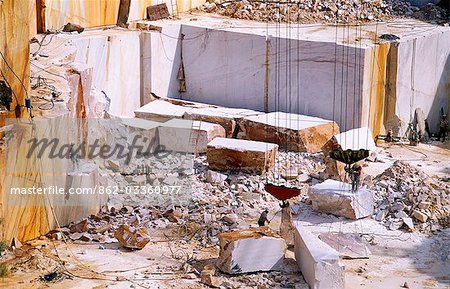 Portugal,Alentejo. White marble quarry near Estremos. The marble produced here is among the best in the world and much of it is exported to Italy. As well as being used for local buildings,the marble chips can be heated in an earth oven to produce whitewash after water has been added,hence the traditional white-coloured buildings across the region.