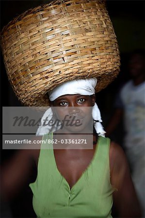 A Sao Tomense woman carries a basket full of cocoa beans at the cocoa processing plant in Agua Izé,a small Sao Tomense village. Cocoa is the country's chief export. Sao Tomé and Principé is Africa's second smallest country with a population of 193 000. It consists of two mountainous islands in the Gulf of New Guinea,straddling the equator,west of Gabon.