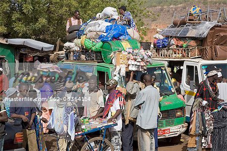 Mali,Bamako. A busy scene at one of Bamako's country bus stations where well-loaded vehicles leave for various destinations in the country when they are full.