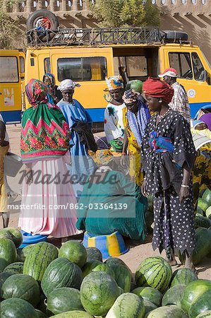 Mali,Djenne. Women selling watermelons at Djenne market. The weekly Monday market is thronged by thousands of people and is one of the most colourful in West Africa.