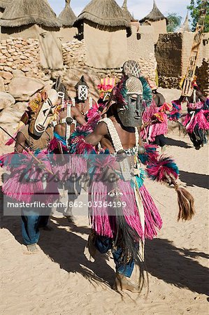 Mali,Dogon Country,Tereli. A mask dance at the Dogon village of Tereli which is situated among rocks at the base of the spectacular 120-mile-long Bandiagara escarpment. The mask dance is performed at funeral ceremonies to appease the dead and speed them on their way to the ancestral world. Mali,Dogon Country,Tereli. A mask dance at the Dogon village of Tereli which is situated among rocks at the base of the spectacular 120-mile-long Bandiagara escarpment. The mask dance is performed at funeral ceremonies to appease the dead and speed them on their way to the ancestral world.
