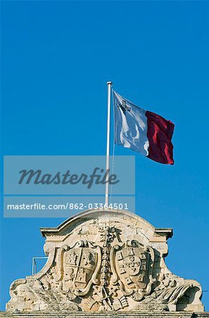 Malta,Valletta. The Maltese flag flies over The Auberge de Castille et Leon,once a grand lodging for the Knights,which now houses the office of the Maltese Prime Minister.