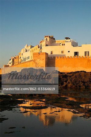 The city walls surrounding the old medina in Essaouira,Morocco. At low tide it is possible to clamber out onto the rocks and look back at the walls from the sea.