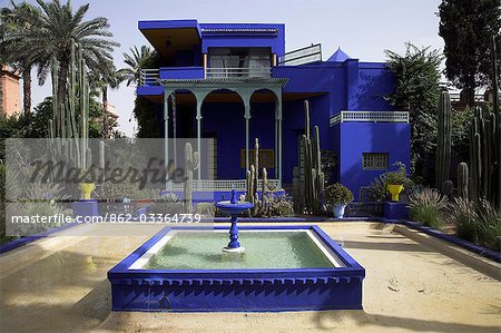 The sub-tropical Jardin Majorelle in the Ville Nouvelle of Marrakech. Designed by the French painter Jacques Majorelle who lived here from 1922 to 1962,it is now owned by the fashion designer Yves Saint-Laurent. The central blue building is also home to the Museum of Islamic Art.