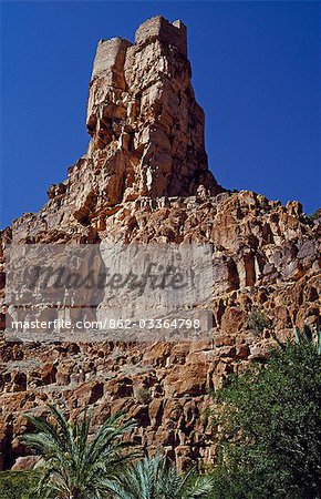 Morocco,Anti-Atlas Mountains,nr. Id-Aissa (aka Amtoudi). Perched high on a shaft of rock,the agadir,or fortified Berber granary,of Agalouil looms spectacularly over the Boulgous Gorge in the southern flanks of the Anti-Atlas range near Id-Aissa.