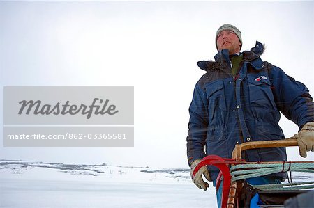 Norway,Troms,Lyngen Alps. Veteran Polar Explorer Norwegian Per Thore Hansen uses his dog sled team to cross the Lyngen Alps inland from Tromso in northern Norway. .