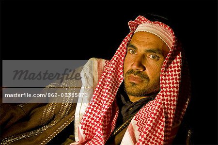 Jordan,Petra Region. A Beduin man relaxing in the evening by the campfire