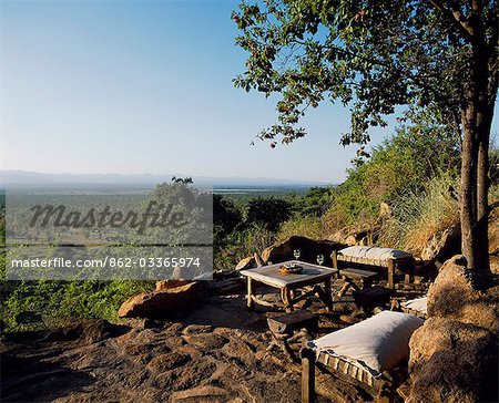 Sundowners at the Rock Bar at Elsa's Kopje,with panoramic views across Meru to the Nyambeni Hills.