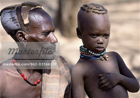 A proud Turkana father and his young daughter. Both their hairstyles are typical of tribal custom in the west of Turkanaland.