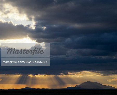 In the late afternoon,storm clouds gather over Amboseli. The mountain in the background is Longido (8,625 feet) situated close to the Kenya/Tanzania border town of Namanga.