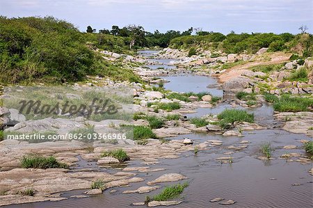 Kenya,Narok district,Masai Mara. A view of the boulder-strewn Talek River,a seasonal river in Masai Mara National Reserve.
