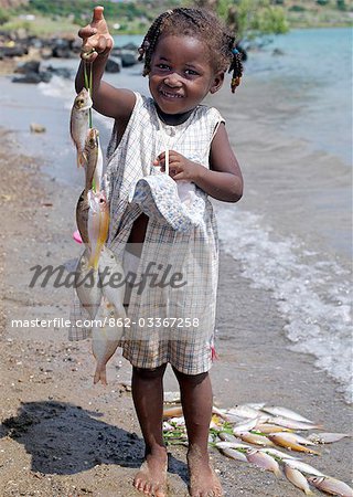 Fishing - girl fishing at the beach Stock Photo