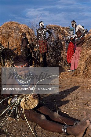 A Nyangatom girl weaves a grass basket. The Nyangatom or Bume are a Nilotic tribe of semi-nomadic pastoralists who live along the banks of the Omo River in south-western Ethiopia.