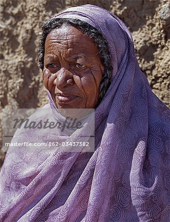 Nubian women wear bright dresses and headscarves even though they are Muslims. Many of the older generation have tribal scars on their faces. .