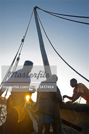 East Africa,Tanzania. Sailing an Arab dhow in Zanzibar. A dhow is a traditional Arab sailing vessel with one or more lateen sails. It is primarily used along the coasts of the Arabian Peninsula,India,and East Africa.