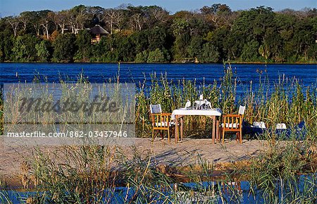 Zambia,Livingstone. The River Club - honeymoon lunch set up on island in the Zambezi River in front of the lodge.