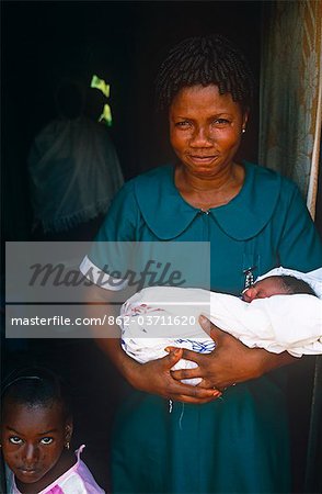 Ghana,Volta Region,Hohoe. Midwife nurse with a baby.