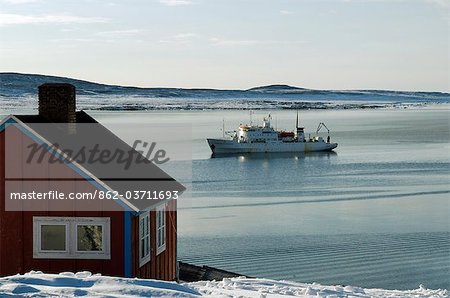 Greenland,Ittoqqortoormiit. The isolated village of Ittoqqortoormiit (Scoresbysund) situated on the north east coast of Greenland. It has 2 food deliveries a year by boat. The Arctic cruise ship Professor Multanovsky,lies anchored in the bay.