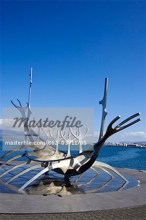 Iceland,Reykjavik. Sulfar (Sun Craft),sculpture close to the old harbour in Reykjavik,it is an abstract representation of a viking ship with the mountains of Akrafjall and Esjan in the background.